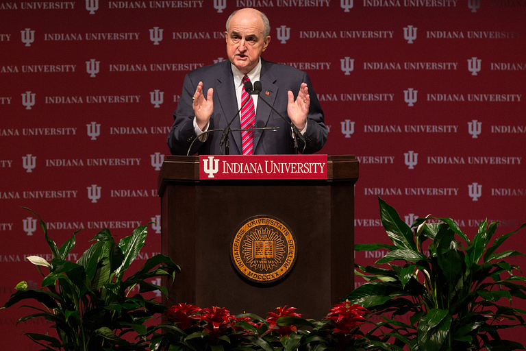 IU President Michael A. McRobbie stands in front of a podium.