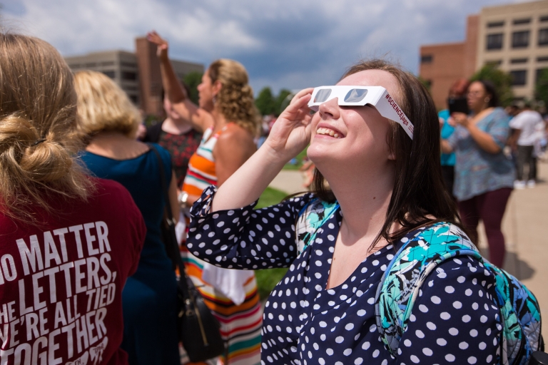 A student looks at the eclipse.