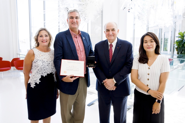 MaryEllen Kiley Bishop, Indiana Gov. Eric Holcomb, Michael McRobbie and Jeeyea Kim stand together