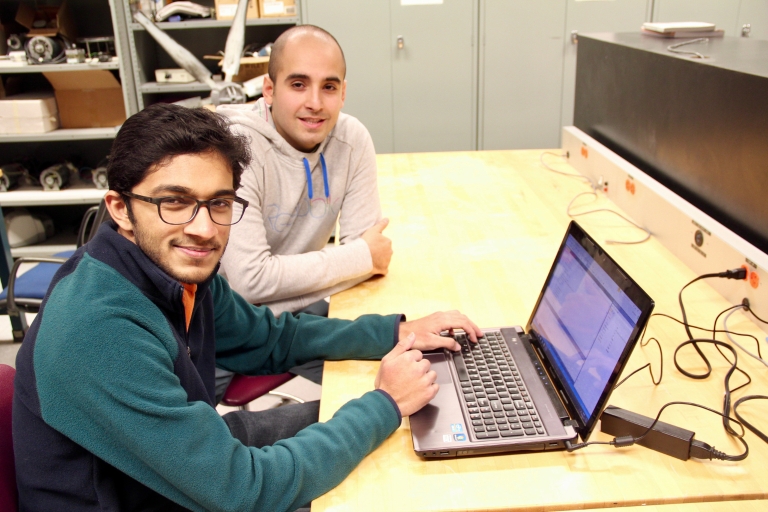 Setu Shah and Mahmood Hosseini work on a computer