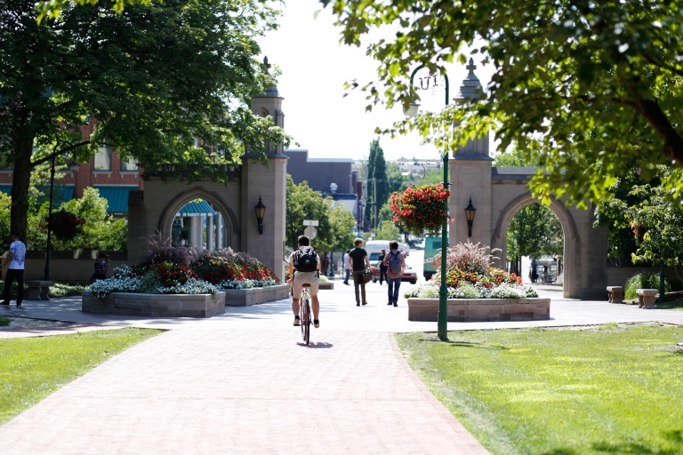 Students walk and ride bikes through Sample Gates at IU Bloomington