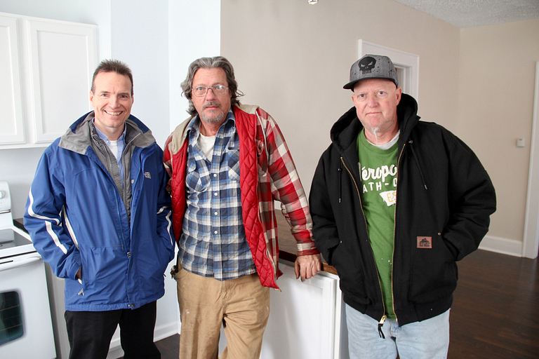 Patrick Monahan, Kevin Norton and Jay Green in a kitchen.