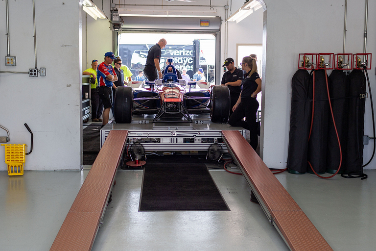 Indy car sits in tech inspection bay