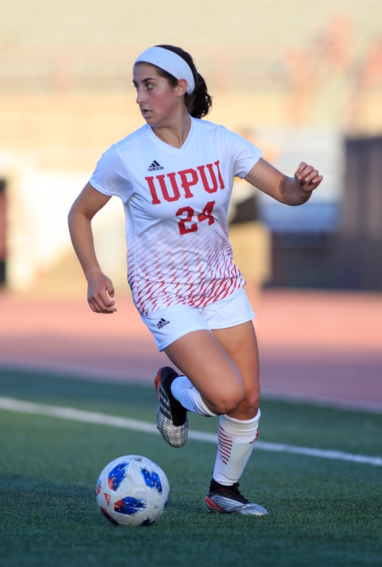 Maya Lacognato dribbles the soccer ball during a match this fall.