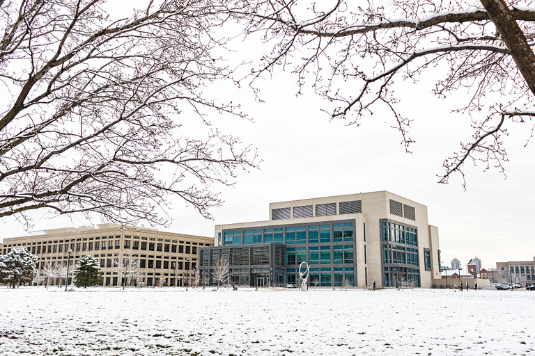 Powdery snow covers the ground and buildings.