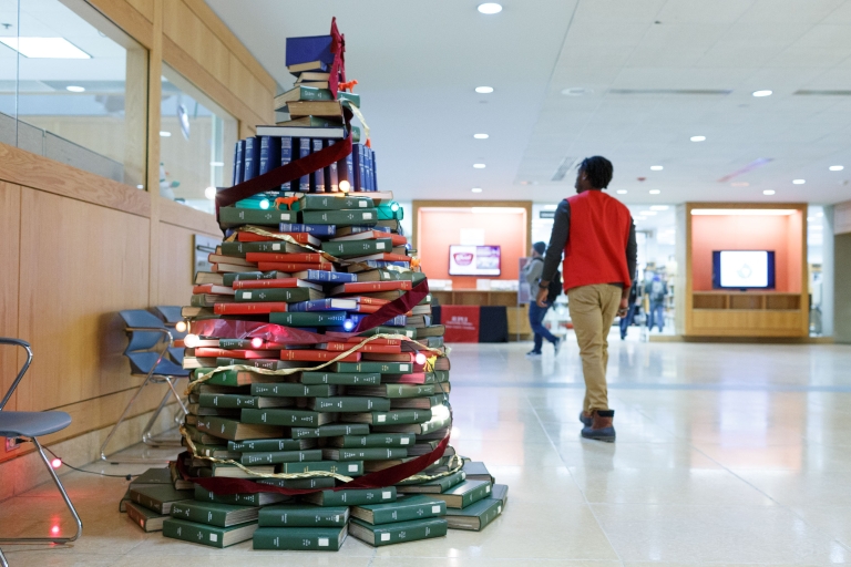 The Christmas tree made of books is decorated for the holiday season.