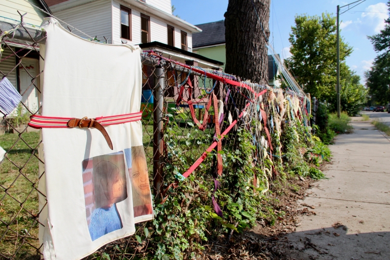 A decorated fence along a street