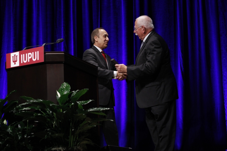 IUPUI Chancellor Nasser Paydar presents the Chancellor's Medallion to William Plater 