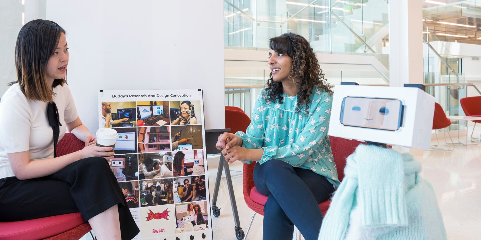 Tingyu Li, left, and Pavithra Ramamurthy sit with their speech therapy robot 