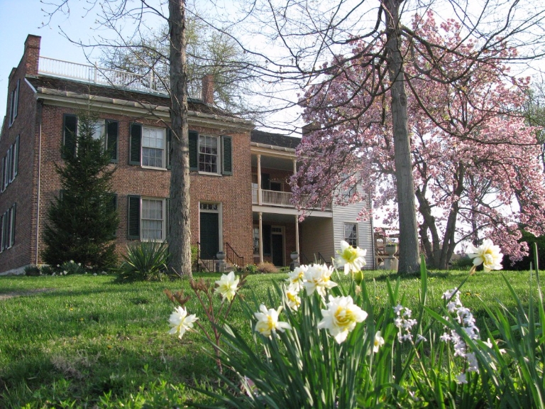 Flowers blooming in front of the Wylie House Museum
