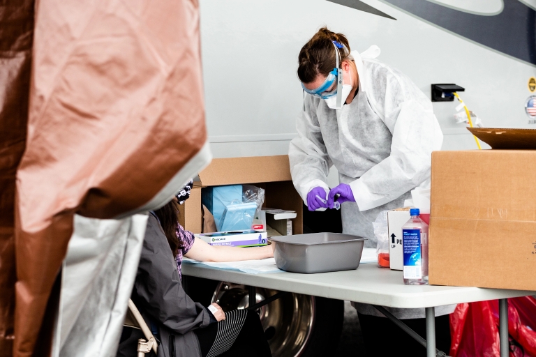A worker prepares to do a SARS-CoV-2 antibody test