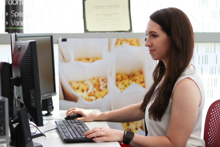 Deidre Bush works at a computer in the Peer Health Educators office.