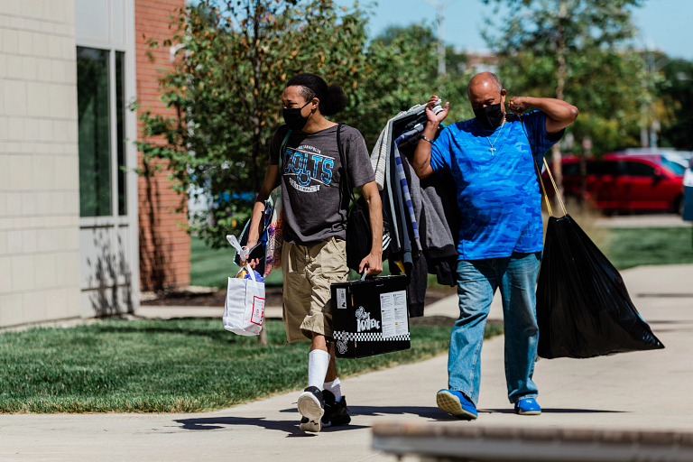 A student and his father carry items into his dorm at IUPUI