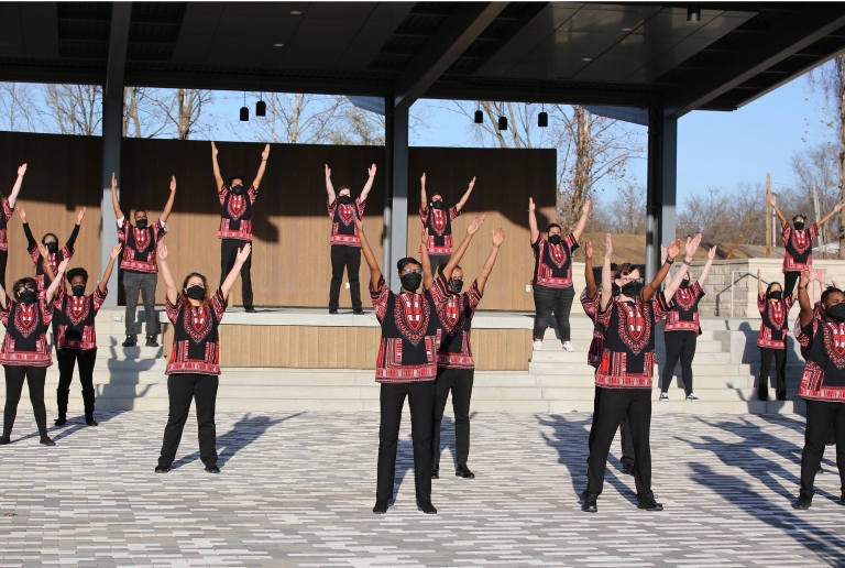 Members of the African American Choral Ensemble rehearse outdoors