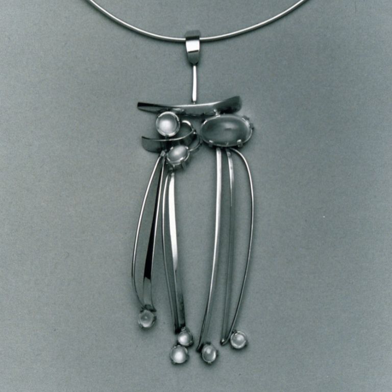 A necklace with a long pendant.
