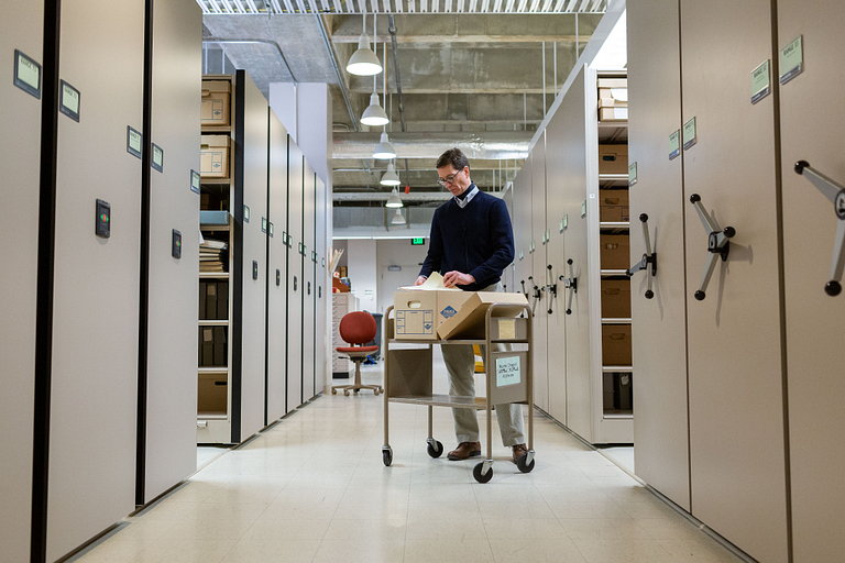 Stephen E. Towne checks a box in the archives.