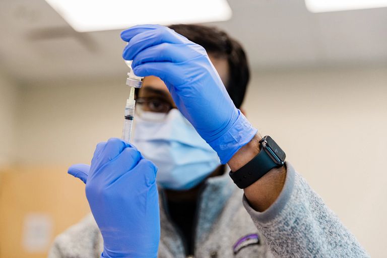 IU medical student fills syringe 
