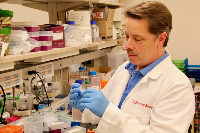 Professor Alex Dent checks a sample in his lab.