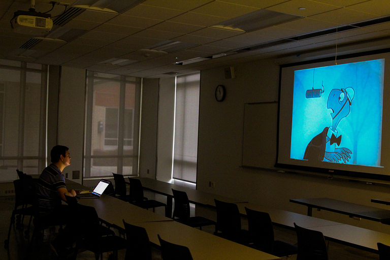 A student takes a break by catching a movie.