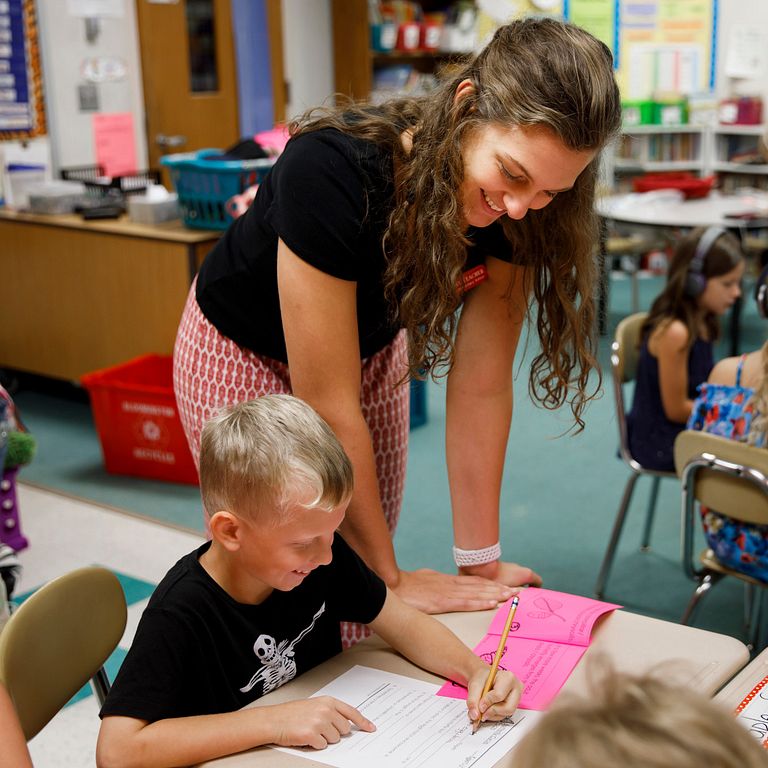 Amanda Cahill works with a student in her second-grade class