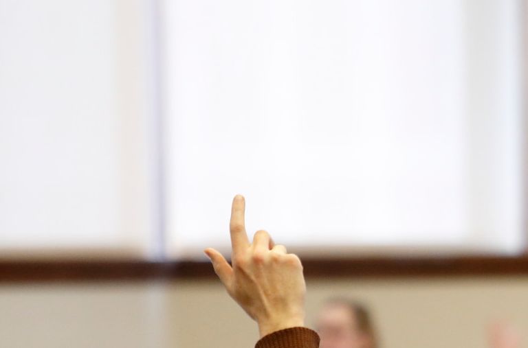 Members of the Bloomington Faculty Council vote during a meeting