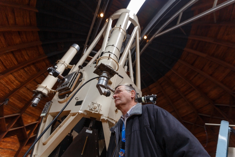 John Shepherd looking through a telescope at the Link Observatory