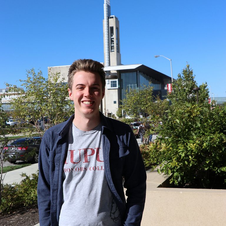 Isaac Lamb standing outside with IUPUI Campus Center in background