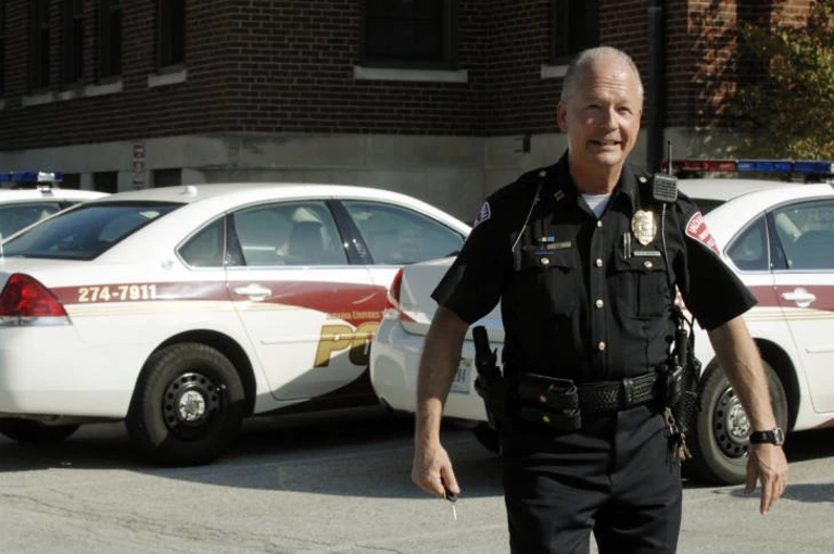 Bill Abston stands outside in his police uniform