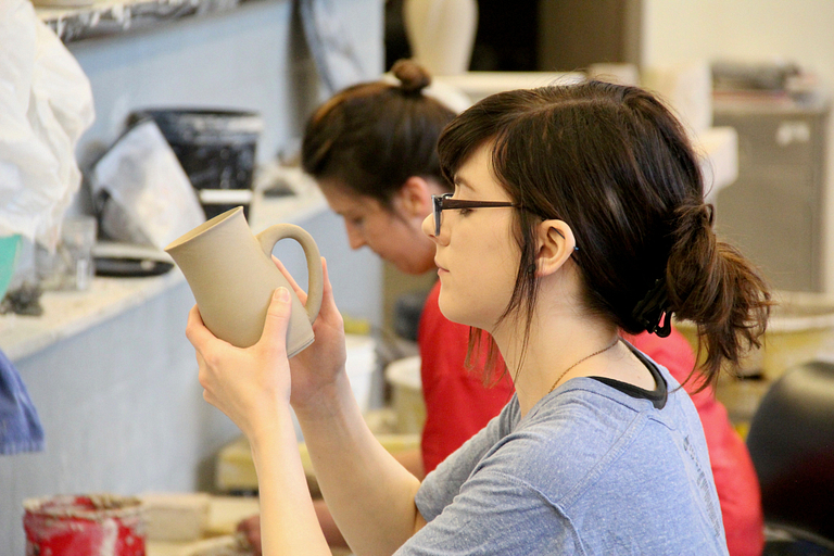 Courtney Murphy attaches a handle to a cup.