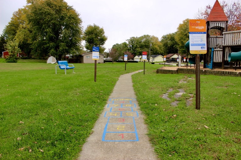 Signs encouraging physical activity line a trail in Mitchell.