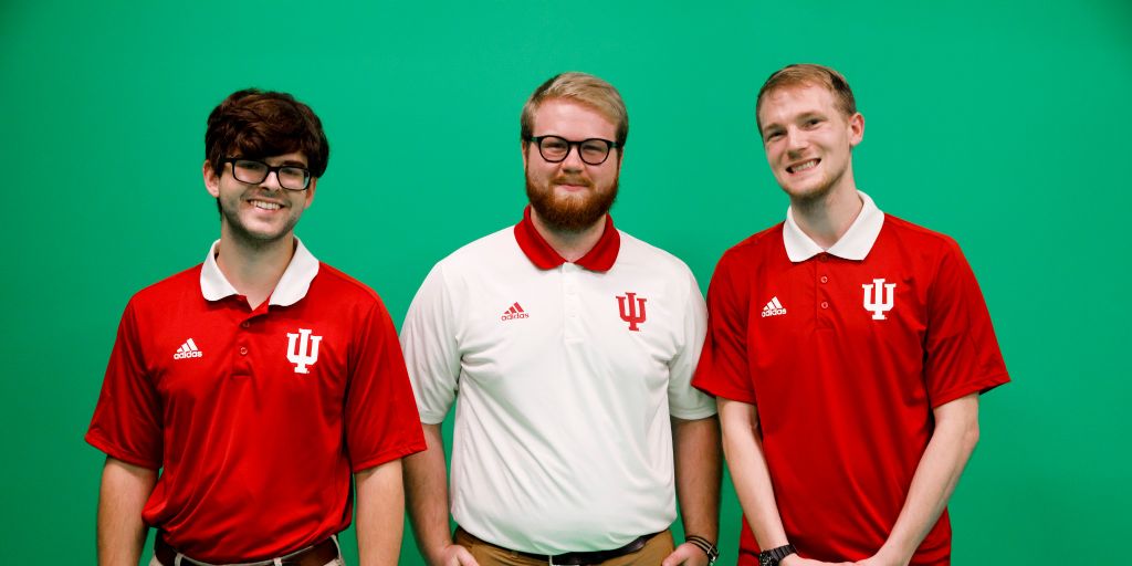 Cuban Center interns stand in front of the green screen