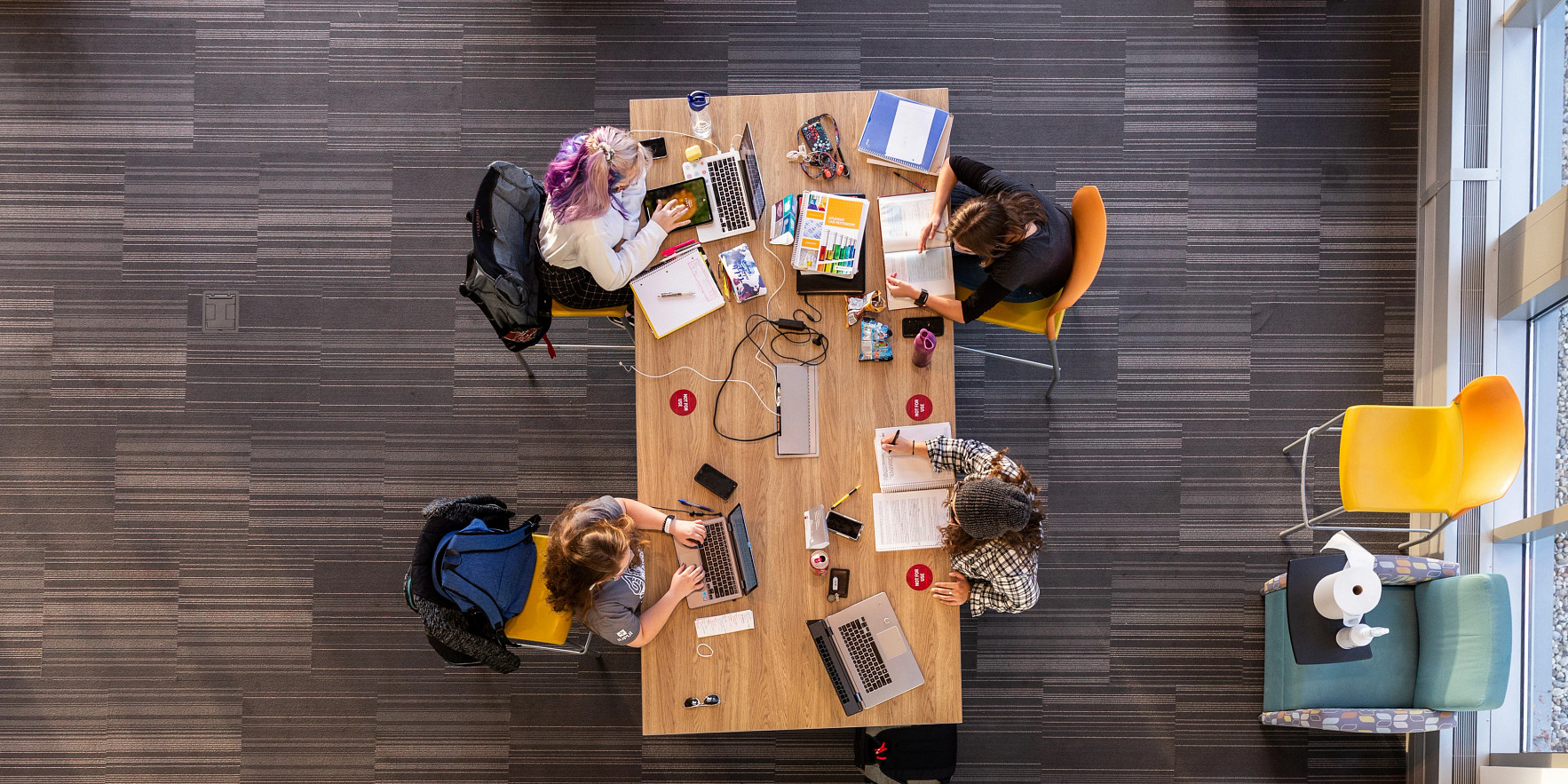 an overhead view of four students working at a table