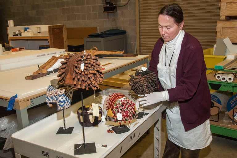 A woman packs masks at the Eskenazi Museum of Art
