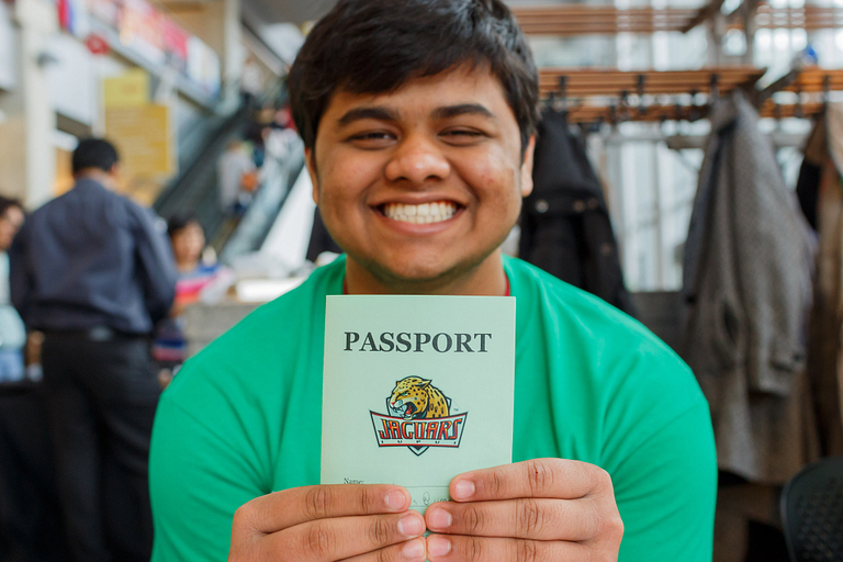 A student holds the GlobalJags passport at the International Festival