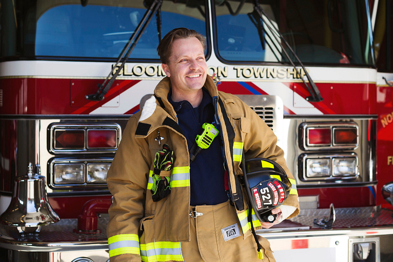 David McDonald stands in front of a firetruck. 