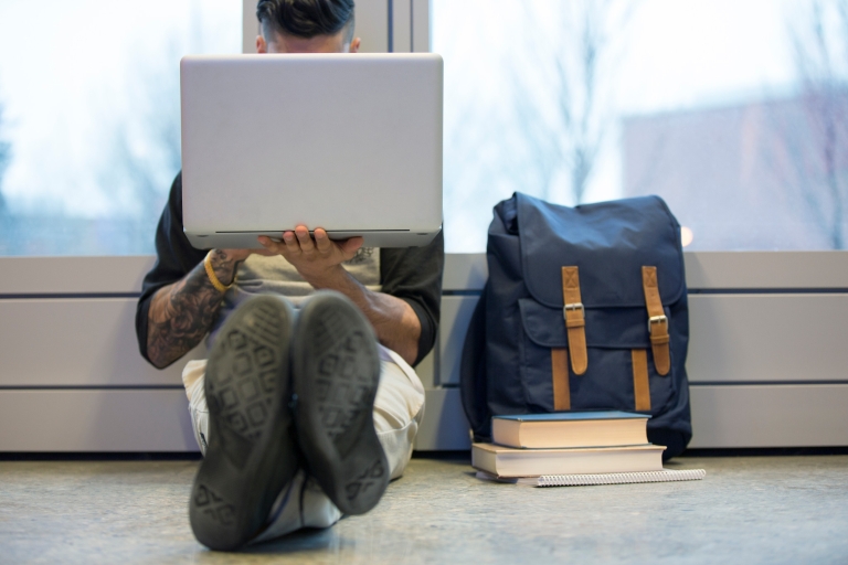 Student sitting on floor with laptop