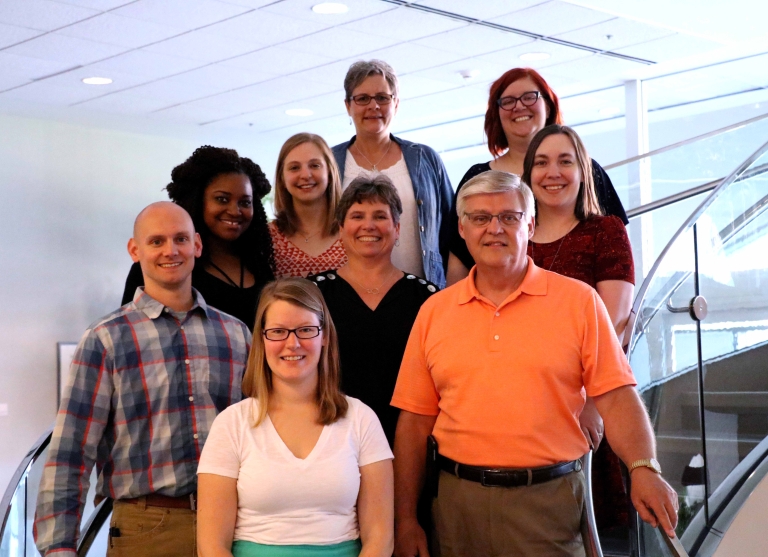 The Health and Life Sciences Advising Center staff poses on some stairs.
