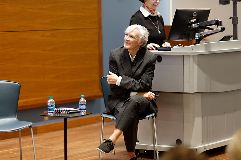 Glenn Close sitting in a lecture hall.