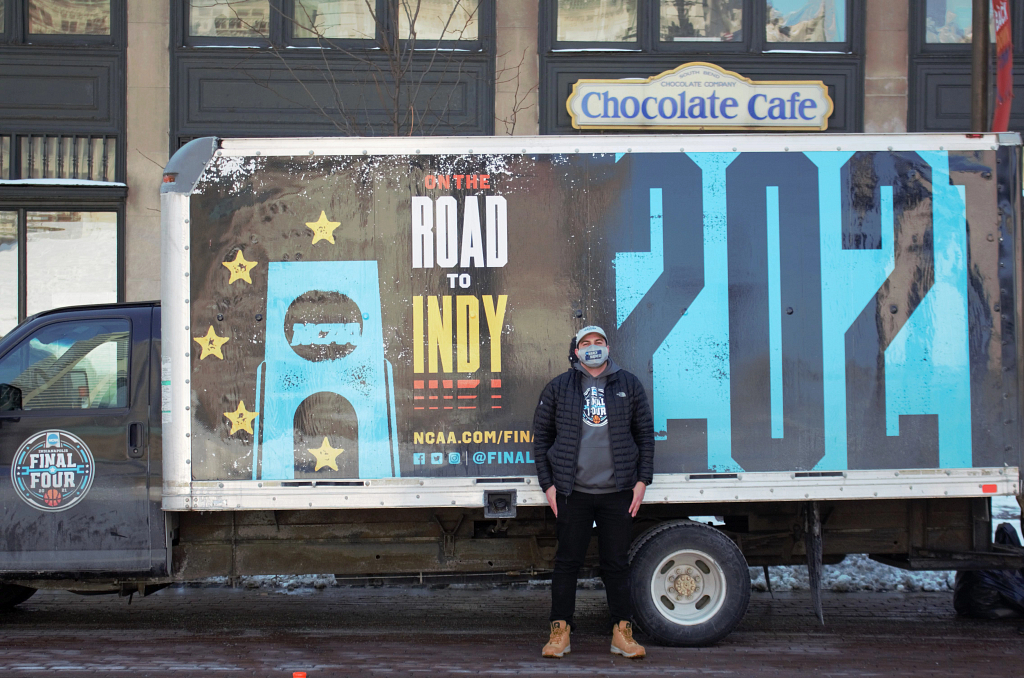 Wally Al-Hamed standing in front of a NCAA branded truck