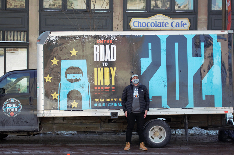 Wally Al-Hamed stands outside a large box truck branded with NCAA Final Four