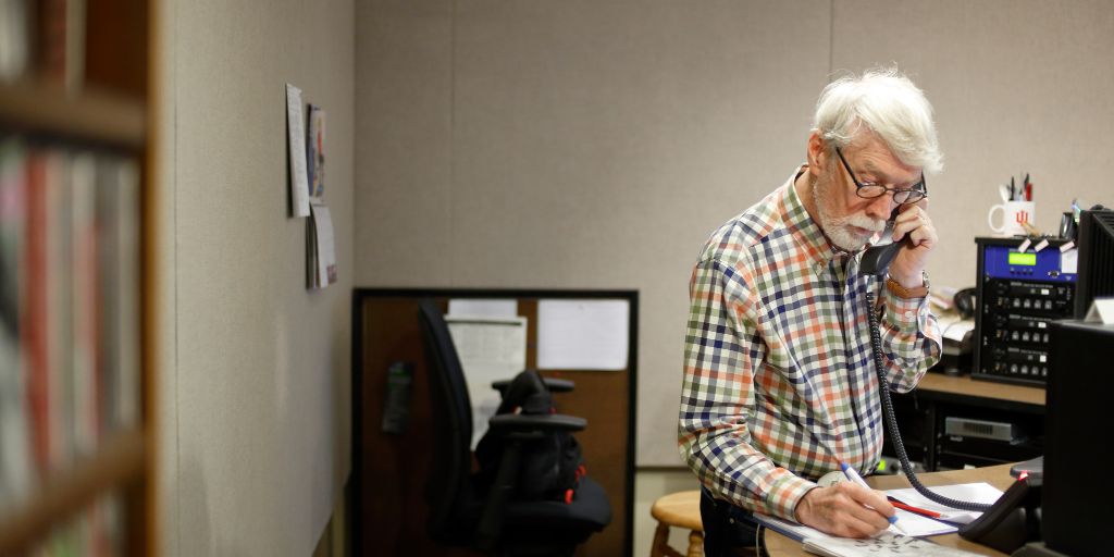 George Walker works on a crossword puzzle while working at WFIU.