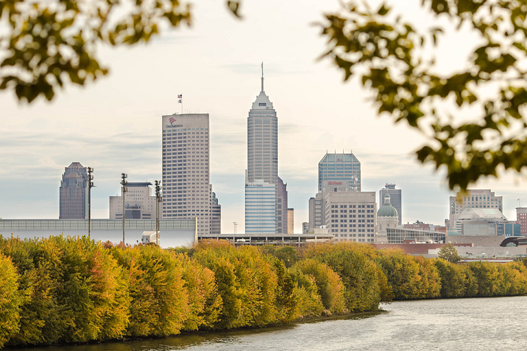The Indy skyline, with a view of White River and autumn trees turning colors
