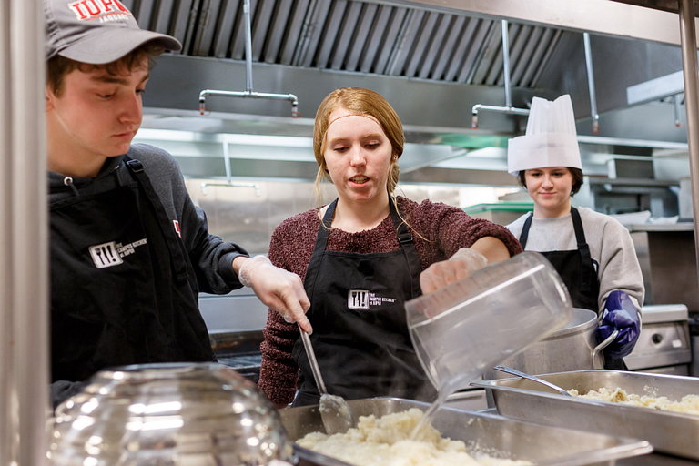 Students make mashed potatoes.