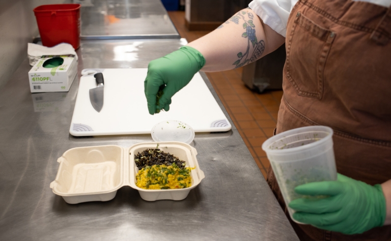 A chef prepares a lentil coconut curry with herbed wild rice