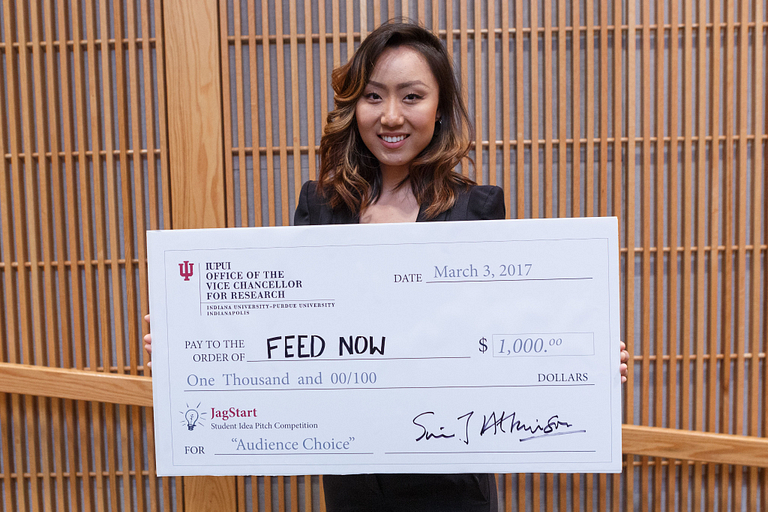 Iris Wang poses with her giant check.