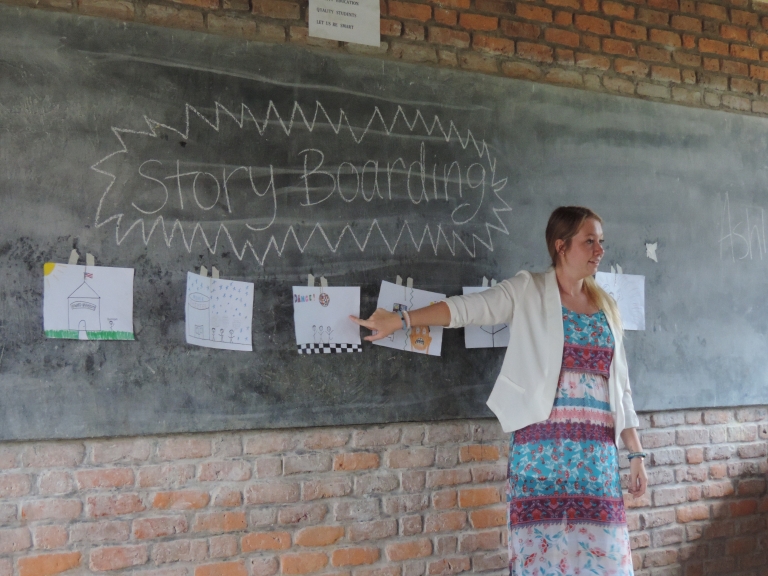 IU student Ashley Wilson points to a chalkboard while teaching a Readers Theater class as part of IU's Books and Beyond program. 