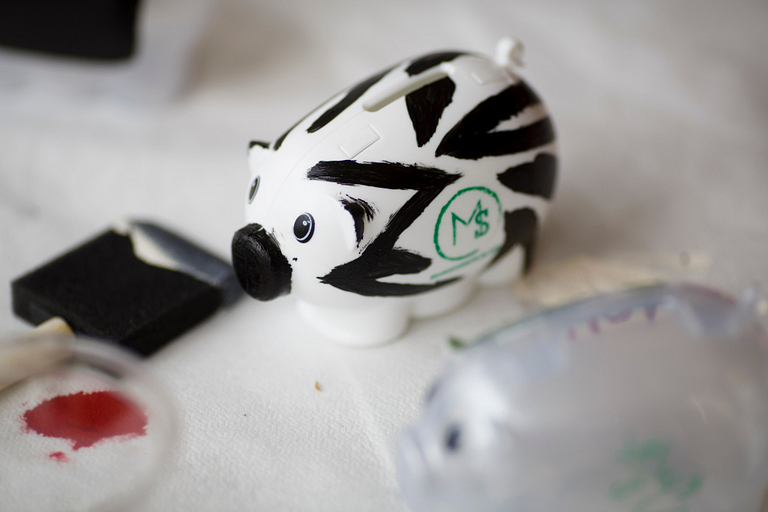 Piggy bank with an 'm' painted on the side.