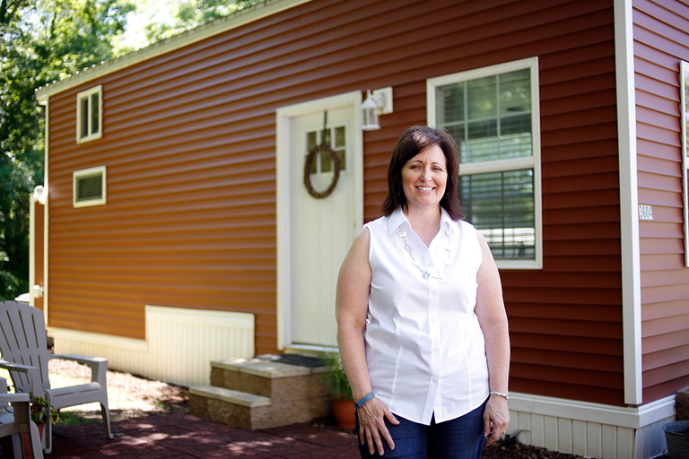 Charla Stonecipher stands outside her home.