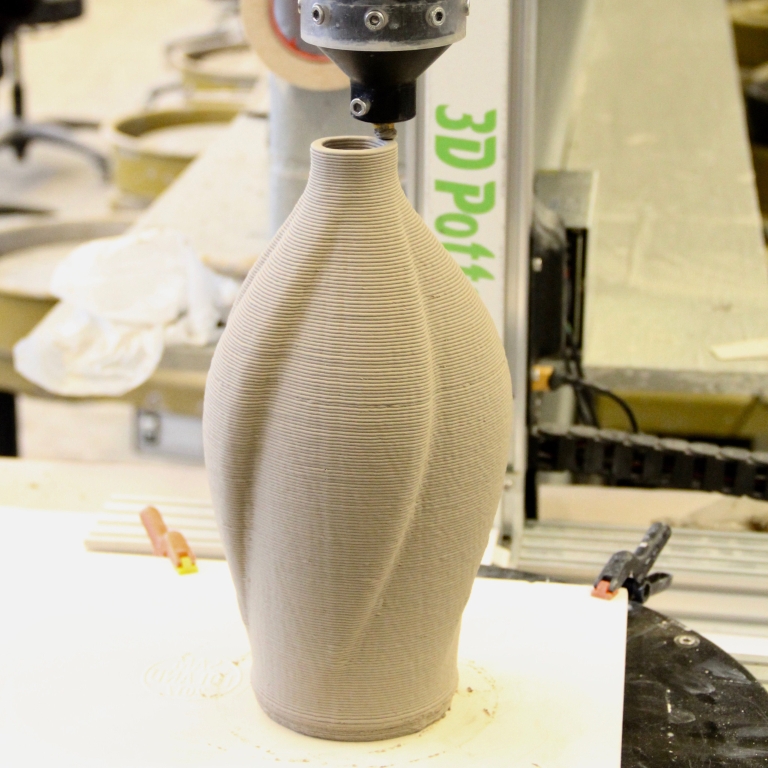 A vase being created on a 3-D printer.