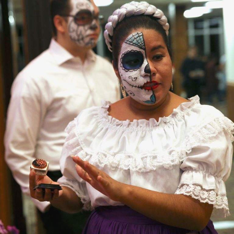  Stephanie Estera of Ballet Folklorico talks to attendees at the Day of the Dead booth